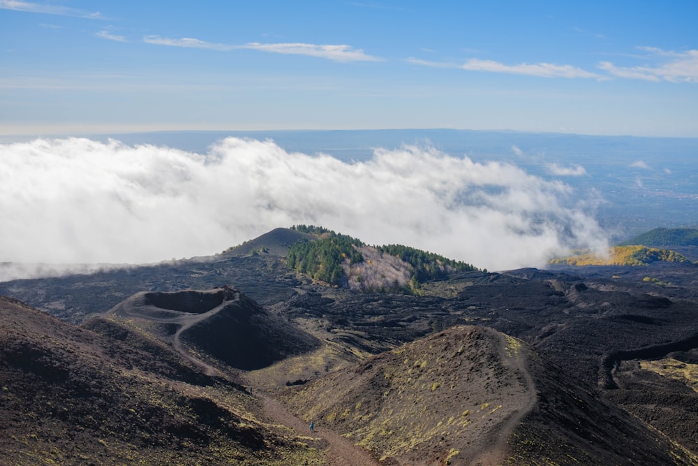 a view of the top of a mountain in the clouds