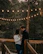 Couple enjoying a private candlelit dinner under the stars surrounded by lush forest.