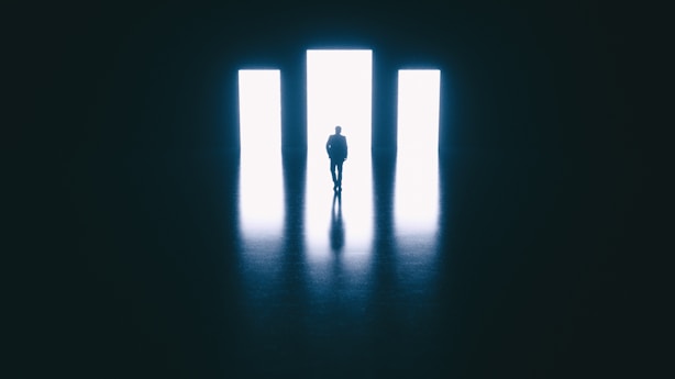 a person standing in front of a doorway in a dark room