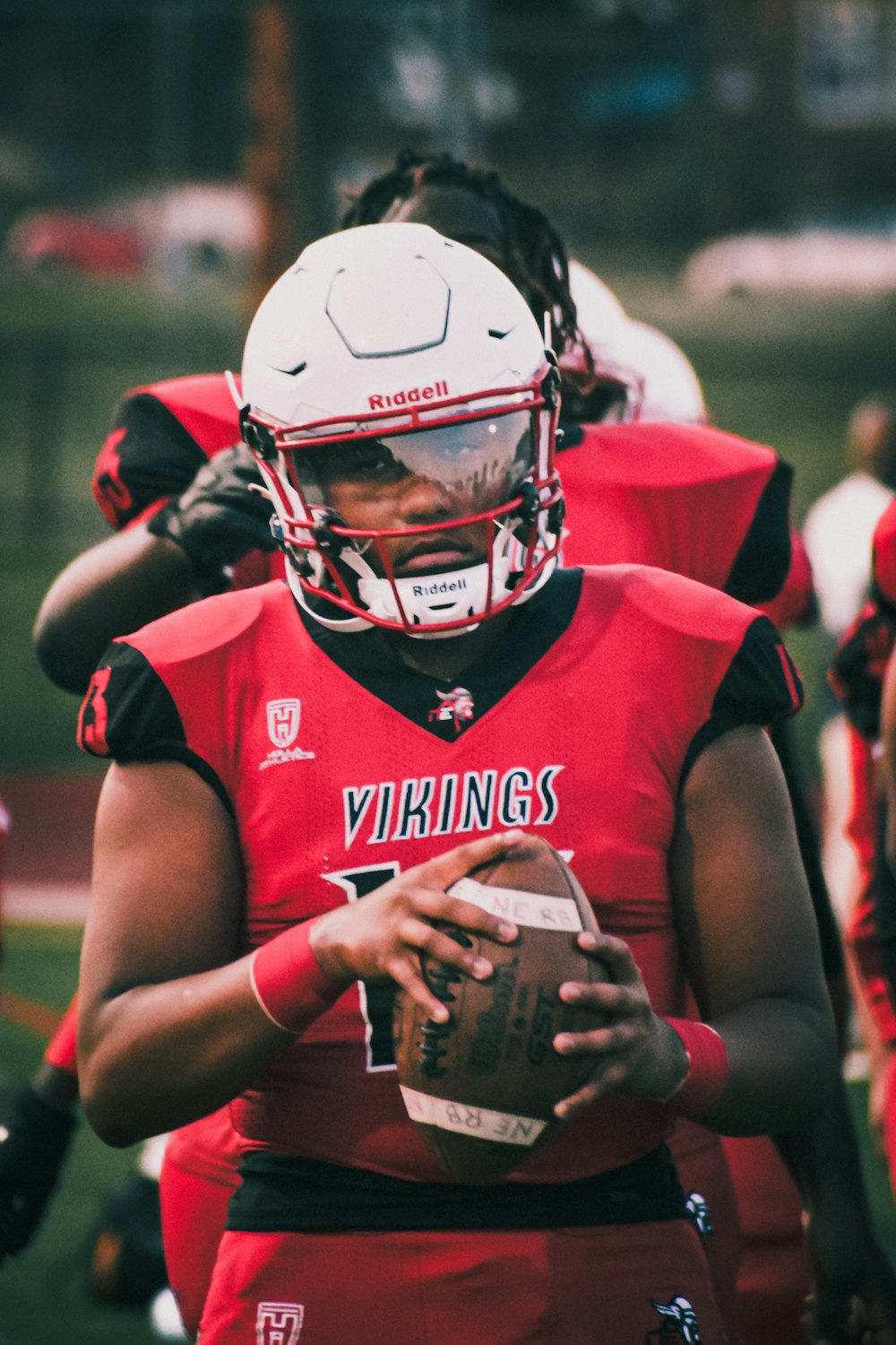 a football player holding a football in his hands