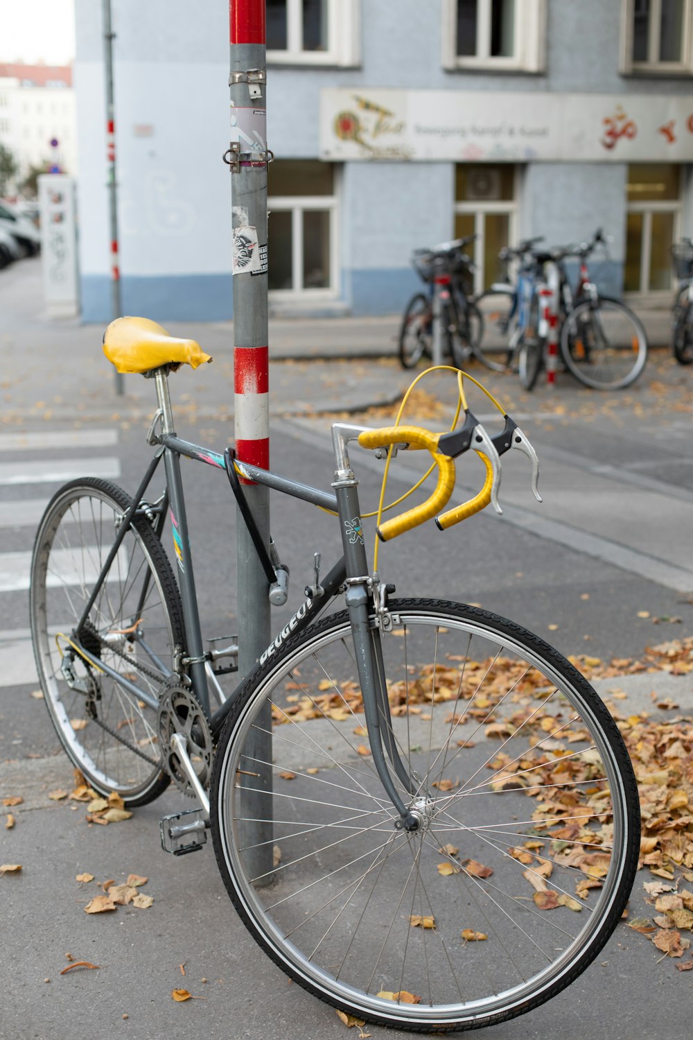 a bicycle chained to a pole on a city street