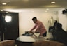 a man ironing clothes on a table in a room