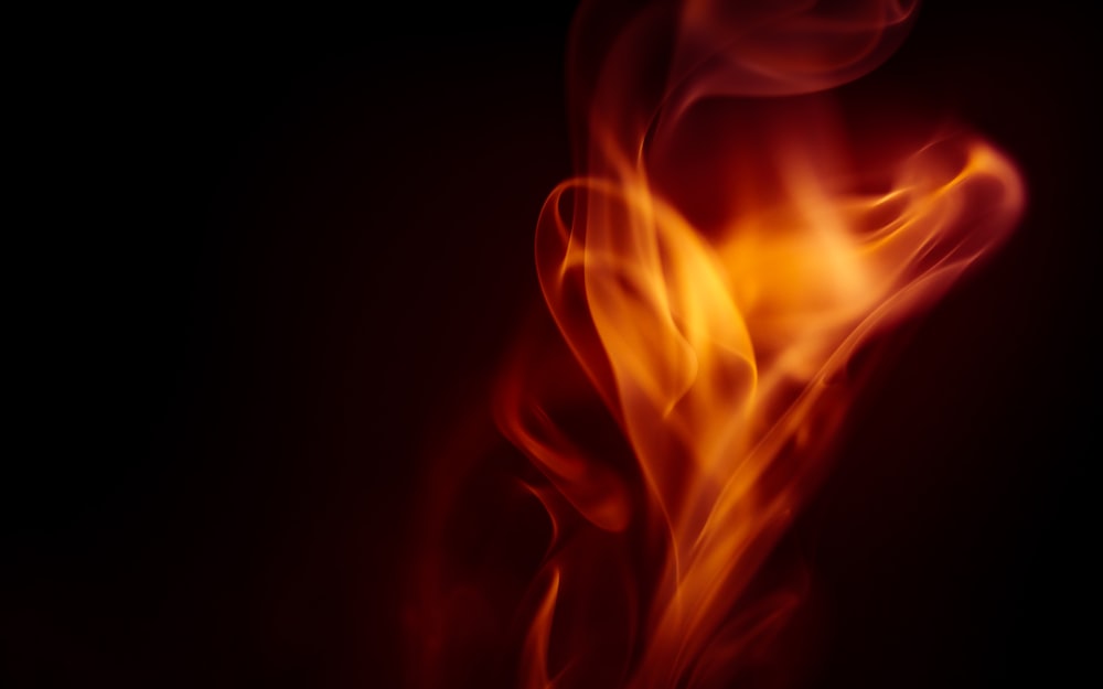 a close up of a red and yellow fire on a black background