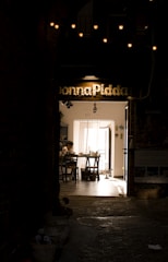 An elegant, dimly lit writer’s room filled with storyboards and scripts pinned on the walls.