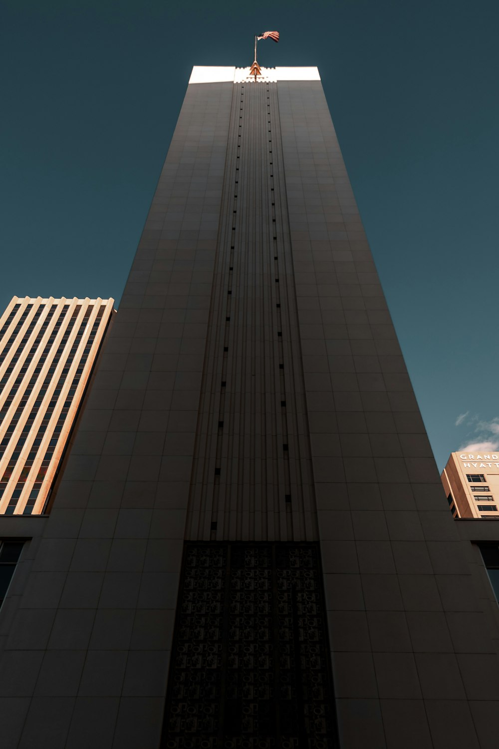 a tall building with a flag on top of it