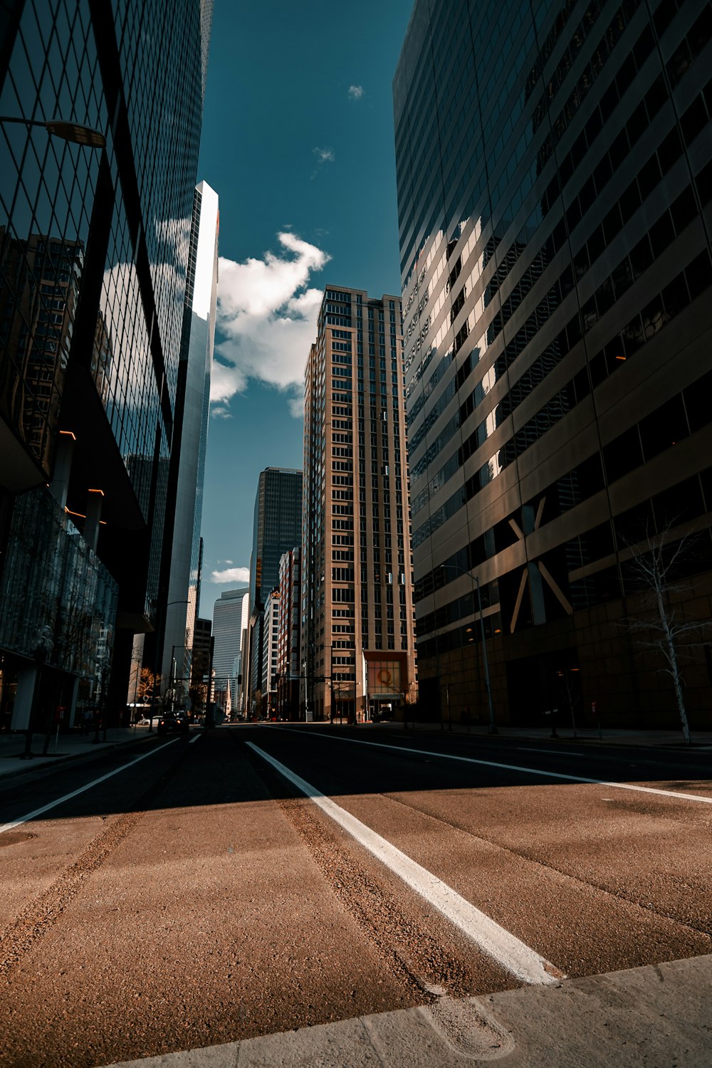 a city street with tall buildings in the background