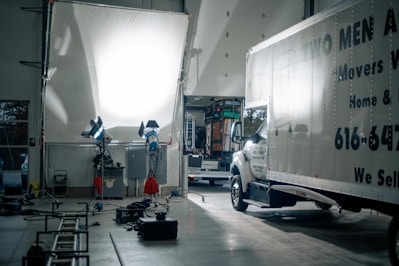 a truck is parked in a garage with other equipment