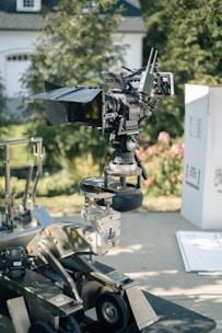 a camera on a tripod in front of a house