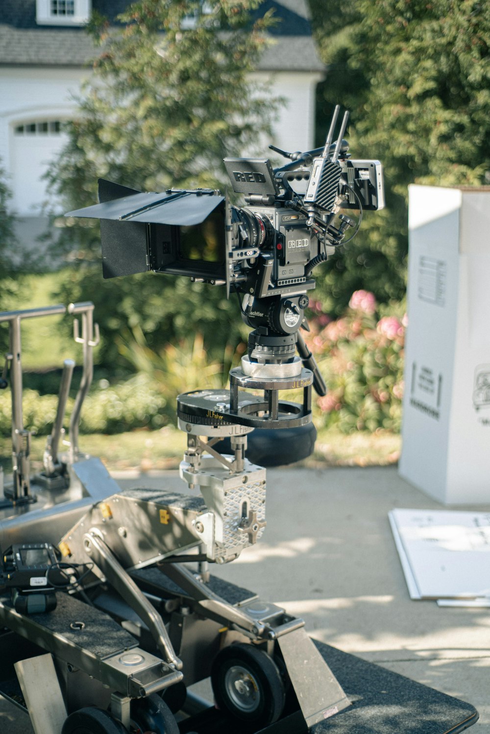 a camera on a tripod in front of a house