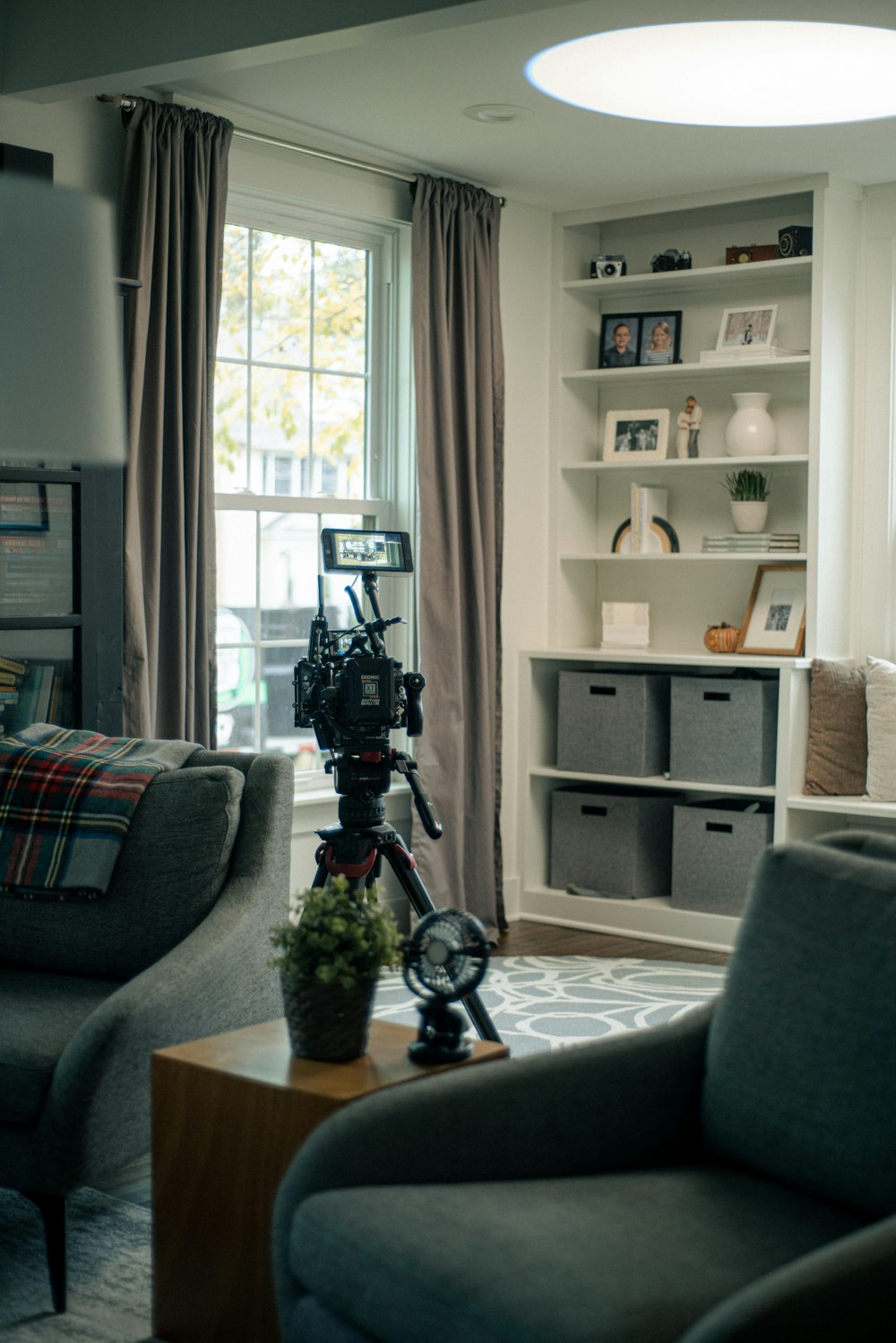 a living room filled with furniture and a large window