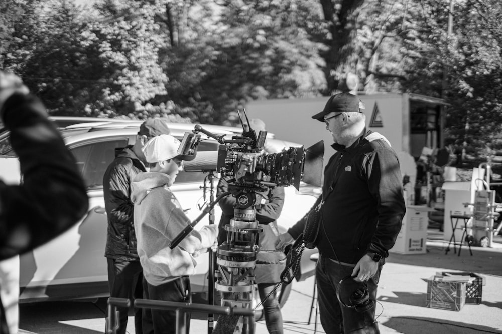 a group of people standing around a camera