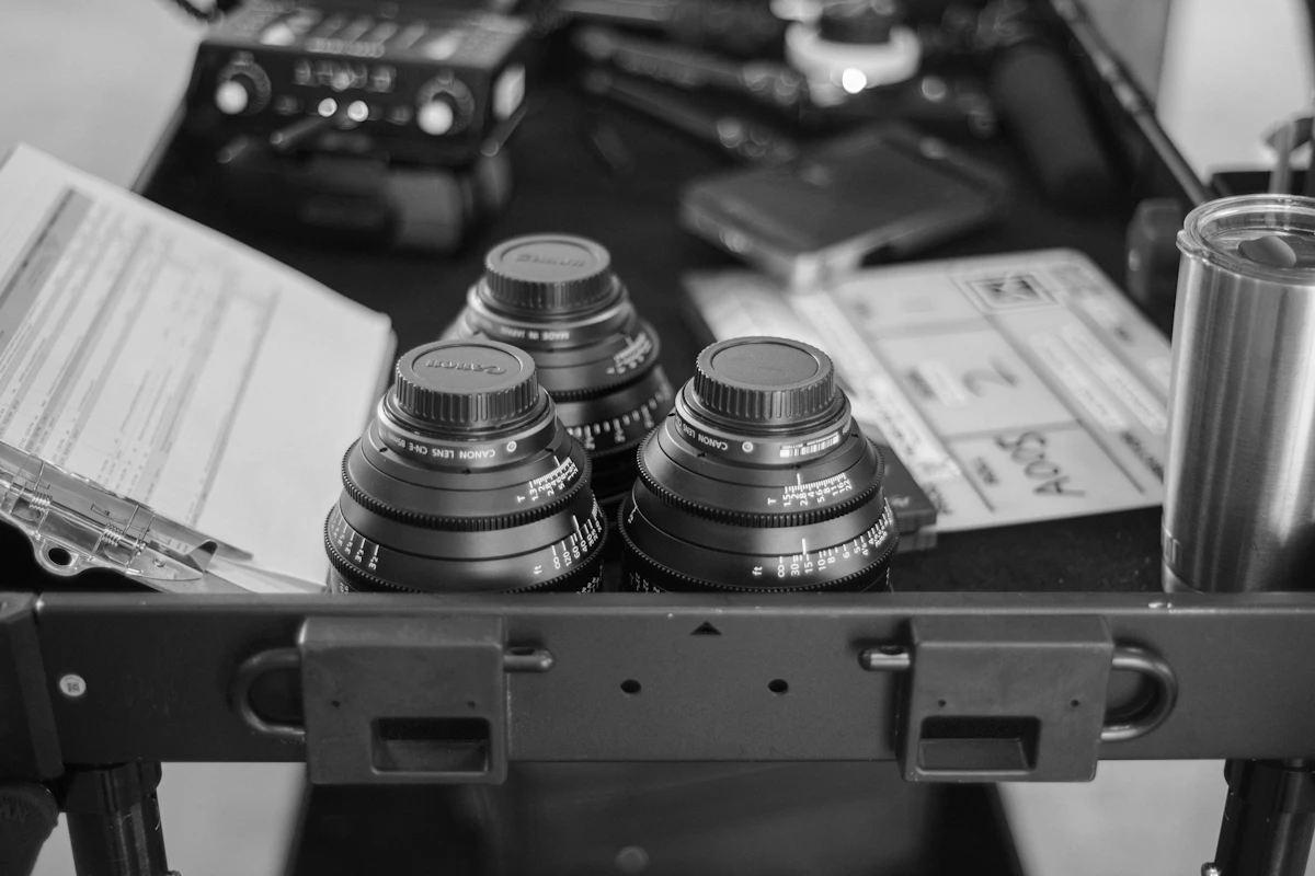 Professional camera equipment and lenses laid out on a table for a wedding shoot
