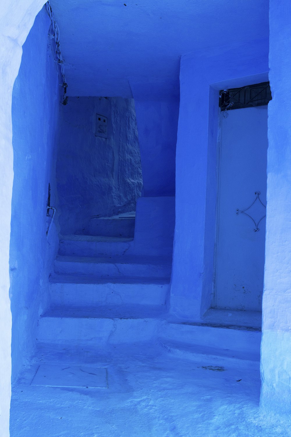 a blue room with a white door and steps