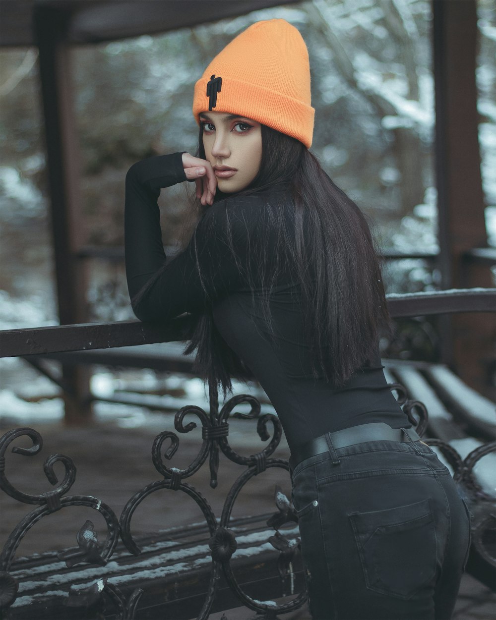 a woman wearing a black top and a orange hat