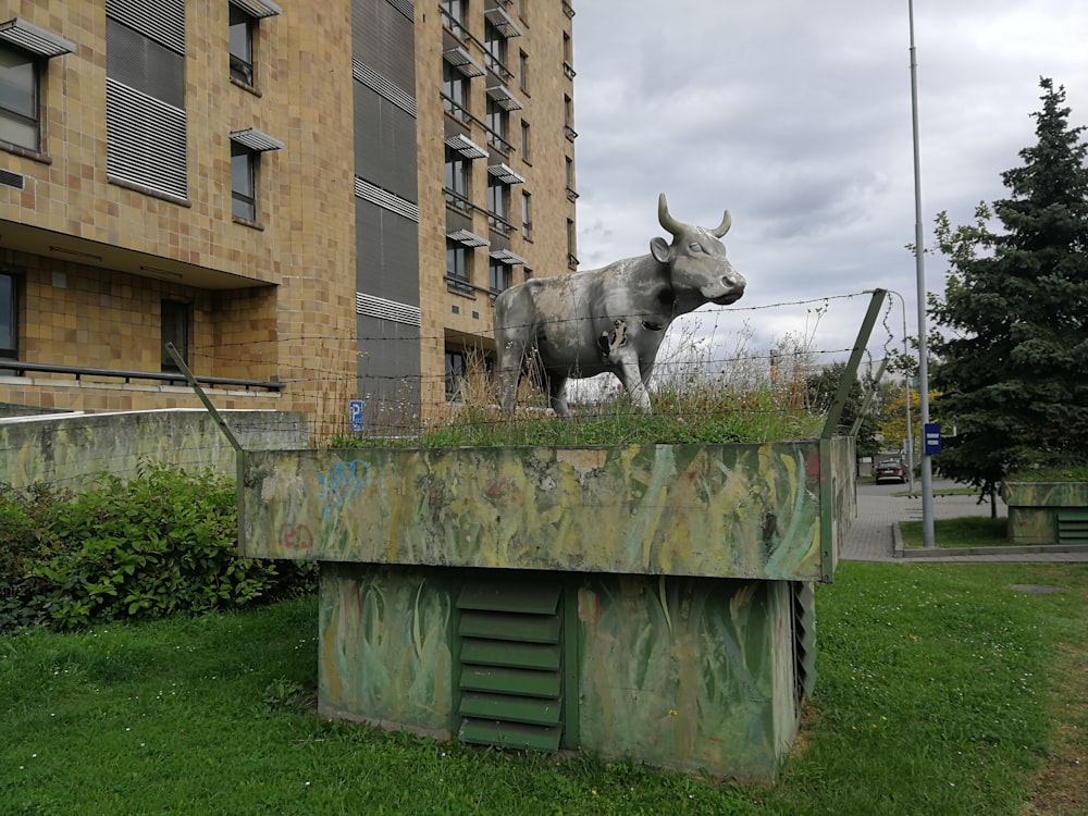 a statue of a bull on top of a building