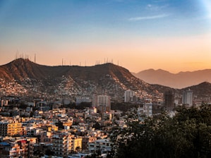 a view of a city with mountains in the background