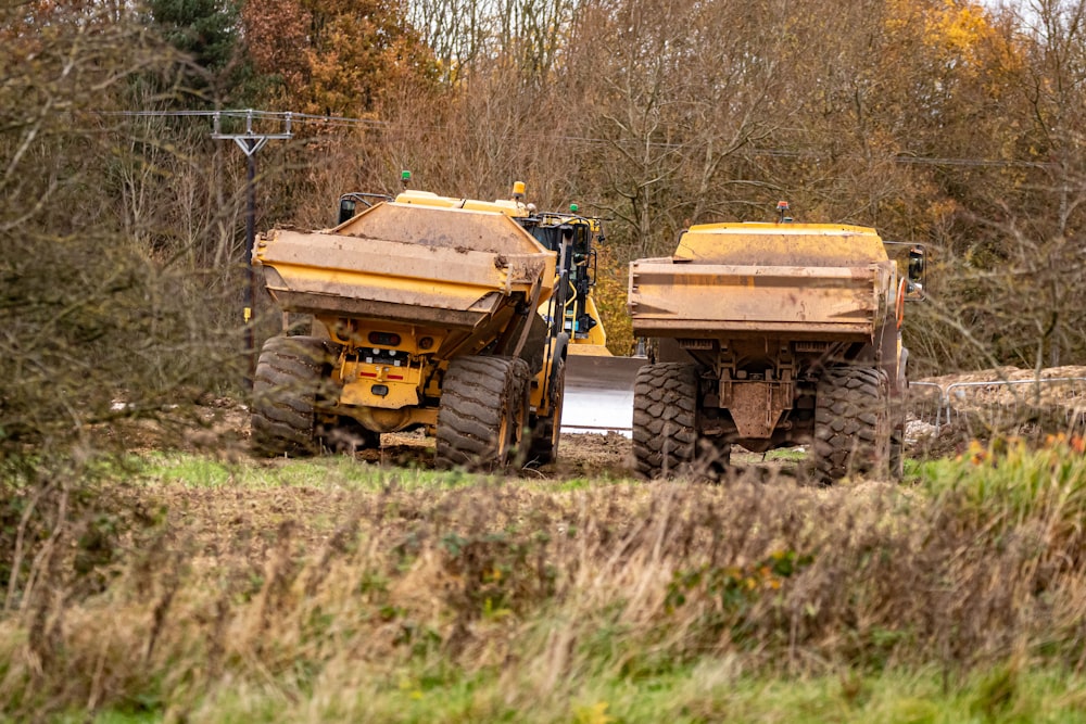 a couple of dump trucks parked next to each other