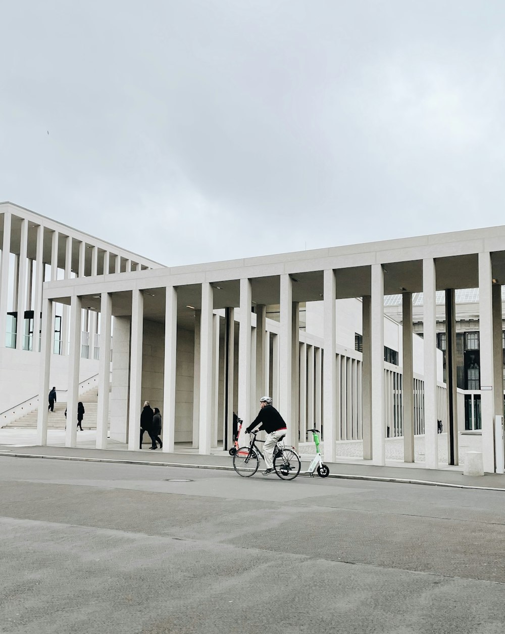 a person riding a bike in front of a building