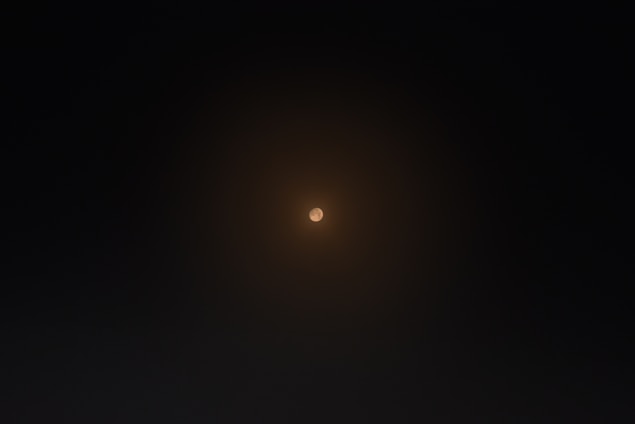 A peaceful, softly glowing circle of light surrounded by subtle spiritual symbols representing chakra energy.