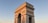 An expansive view of a historical Indian monument bathed in warm sunlight.