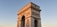 An expansive view of a historical Indian monument bathed in warm sunlight.