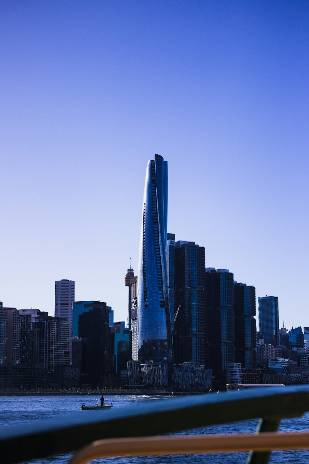 a boat traveling down a river next to a tall building