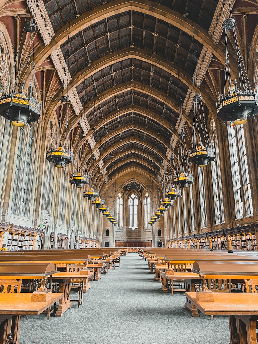 Grand university reading hall with long wooden tables