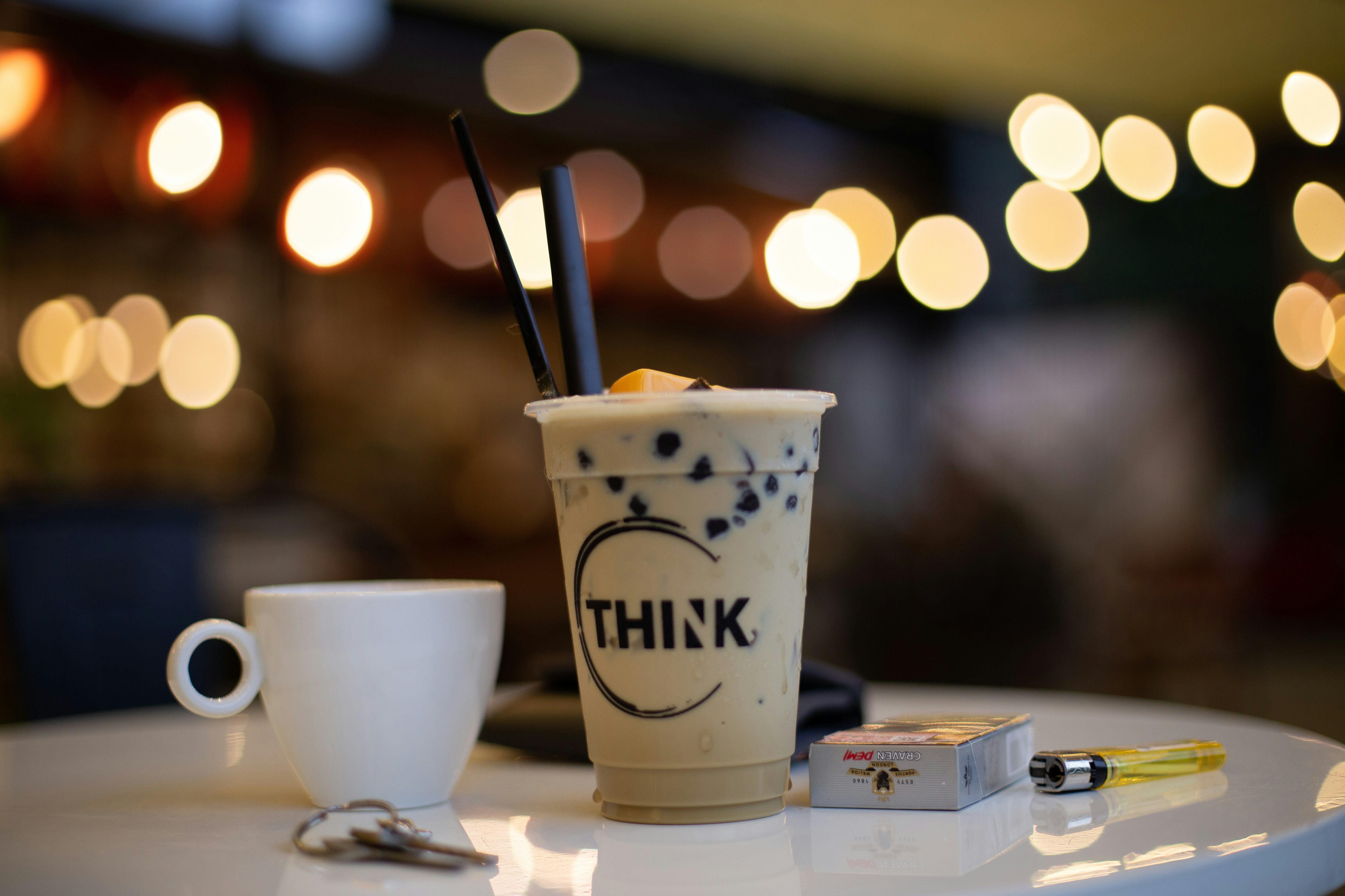 a cup of coffee sitting on top of a white table