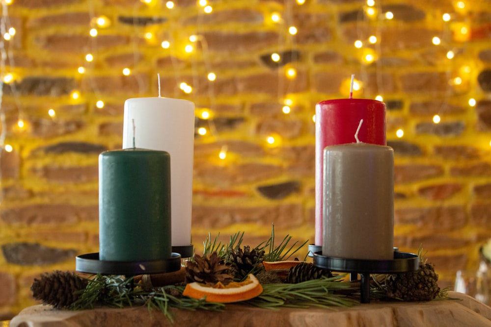 three candles sitting on top of a wooden table