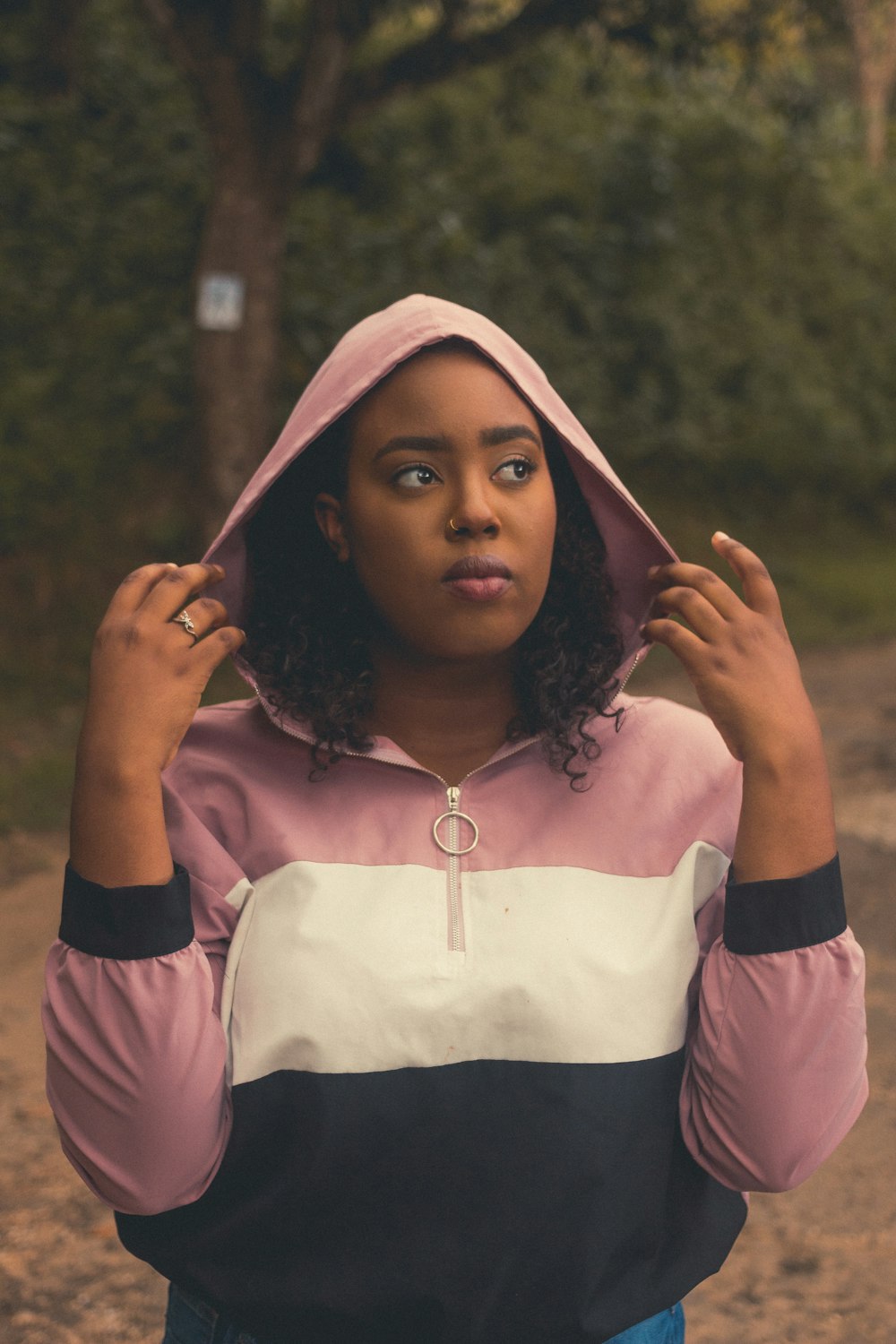 a woman wearing a pink and black hoodie