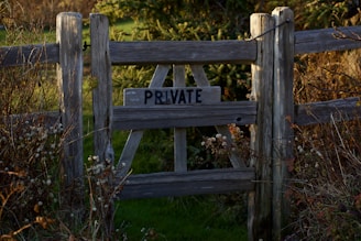 a wooden fence with a private sign on it