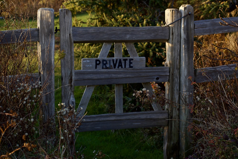 a wooden fence with a private sign on it