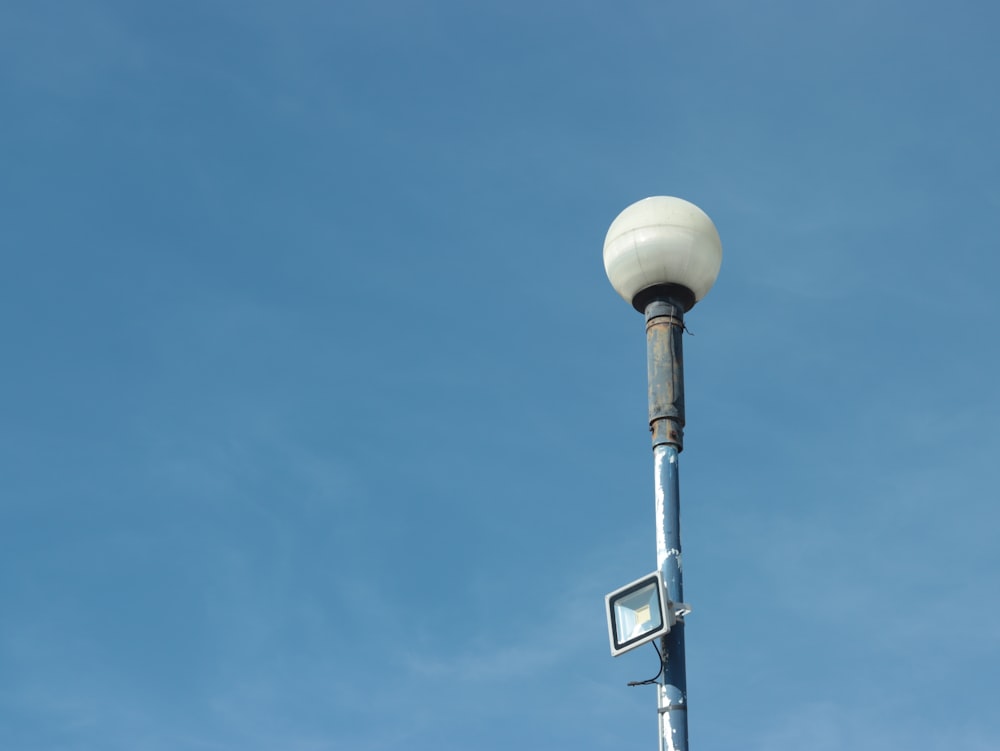 a street light with a blue sky in the background