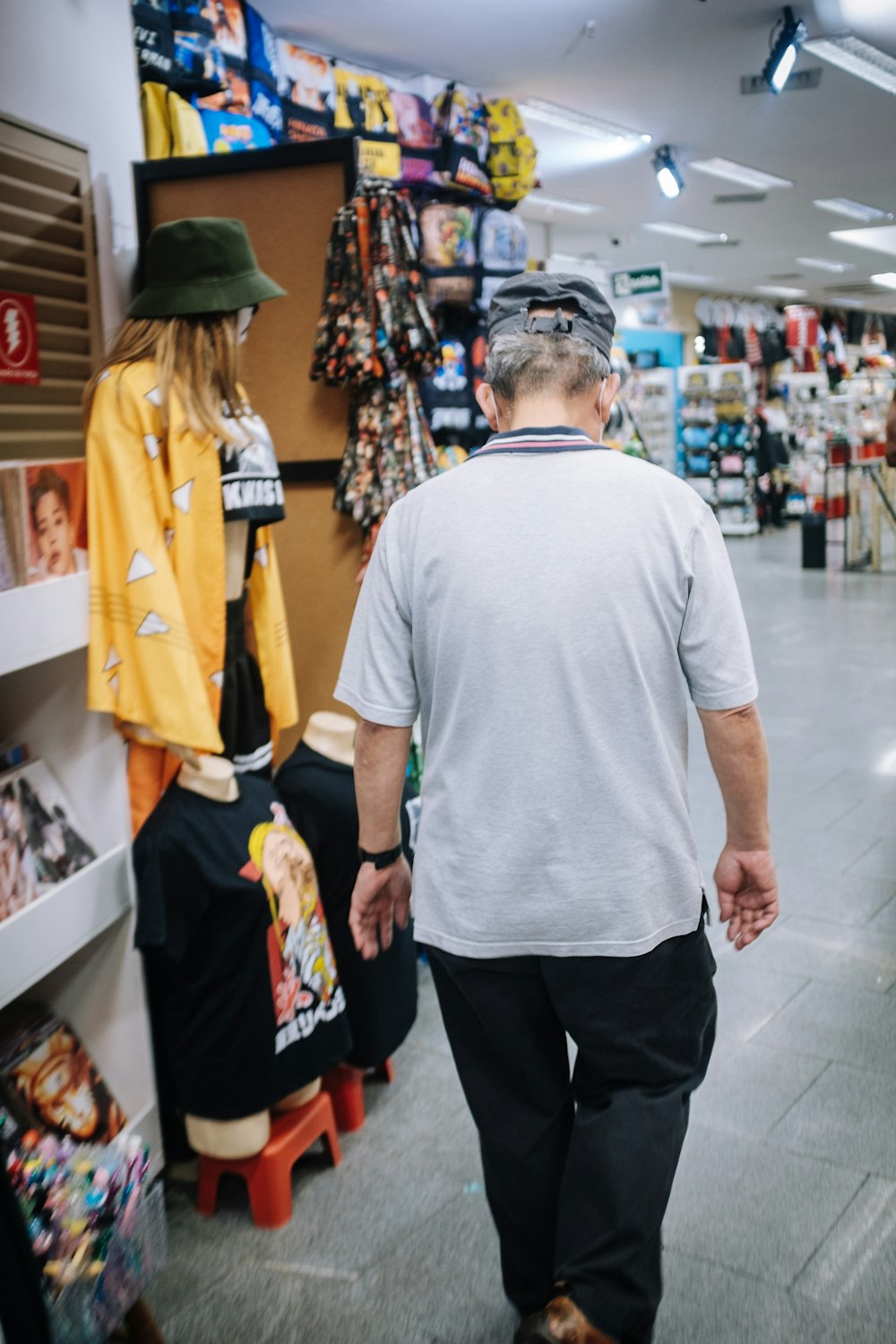 an older man walking down a store aisle