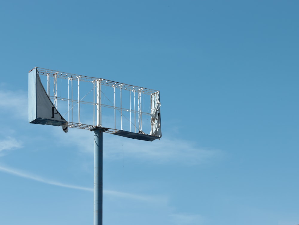 a tall metal pole with a sign on top of it