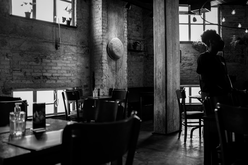 a woman sitting at a table in a restaurant