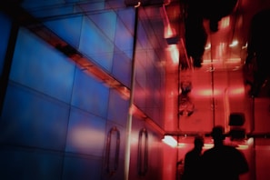 A surreal sci-fi corridor bathed in cool blue tones with sleek futuristic design elements