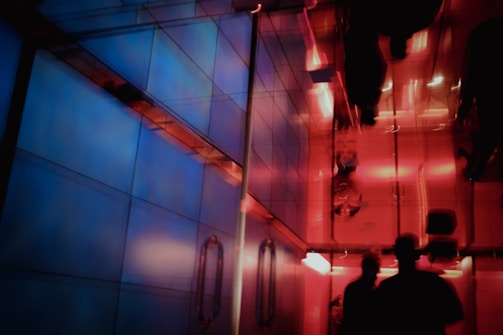 A futuristic hallway illuminated by layered neon blues and sunset peach tones from ambient tech fixtures.