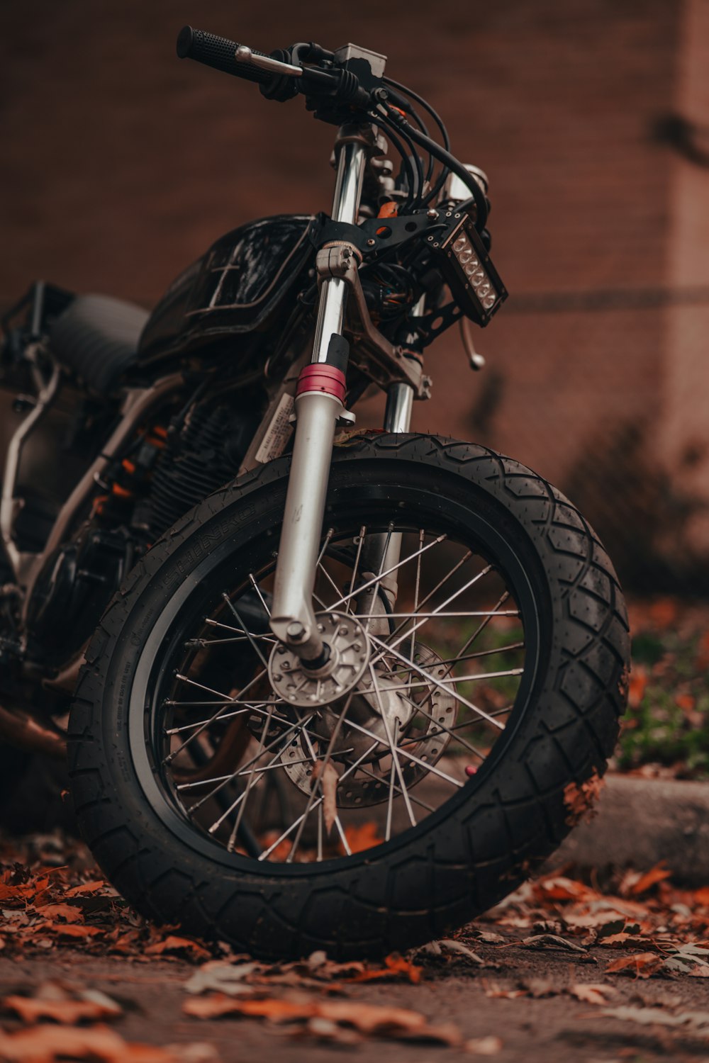 a motorcycle parked in front of a brick building