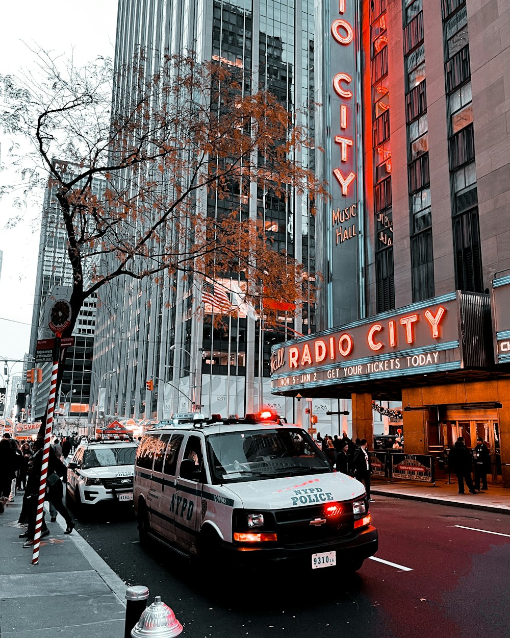 a police car parked in front of a radio city building