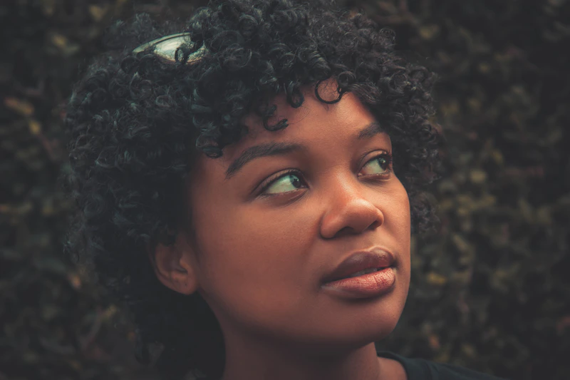 close-up portrait of a curly-haired curvy single