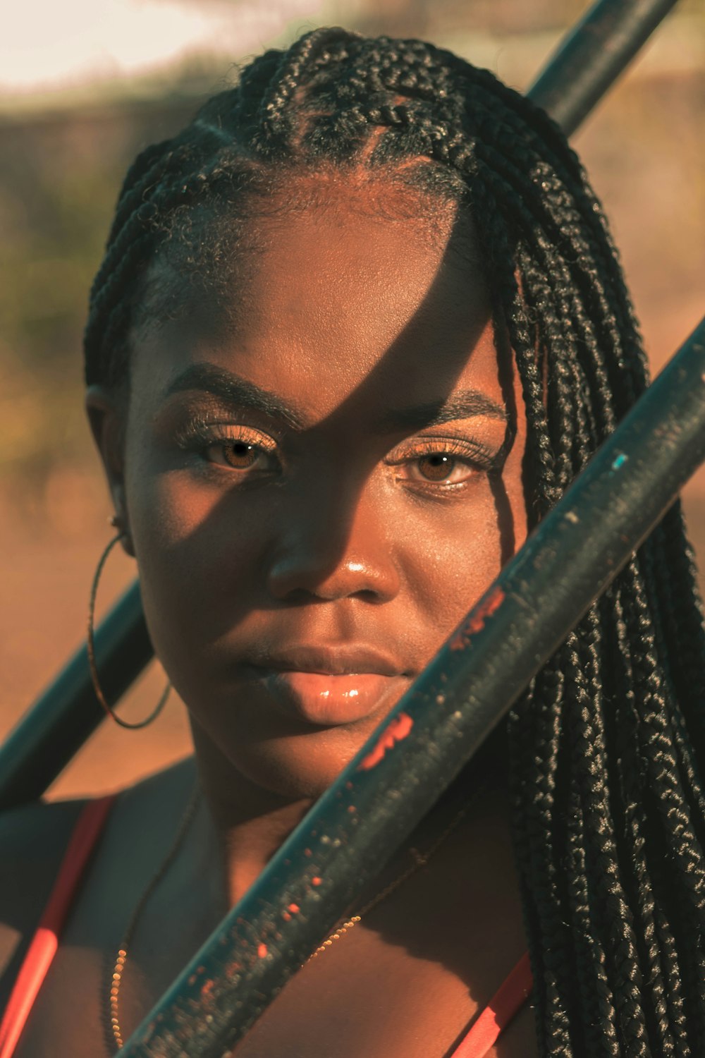 a woman with braids holding a baseball bat