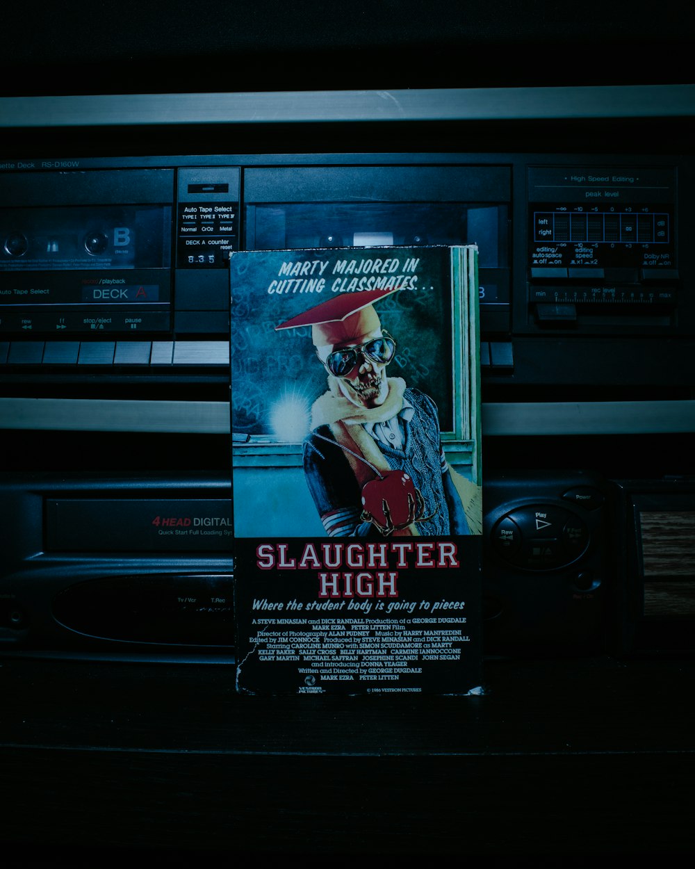 a movie poster on a cd player in a dark room