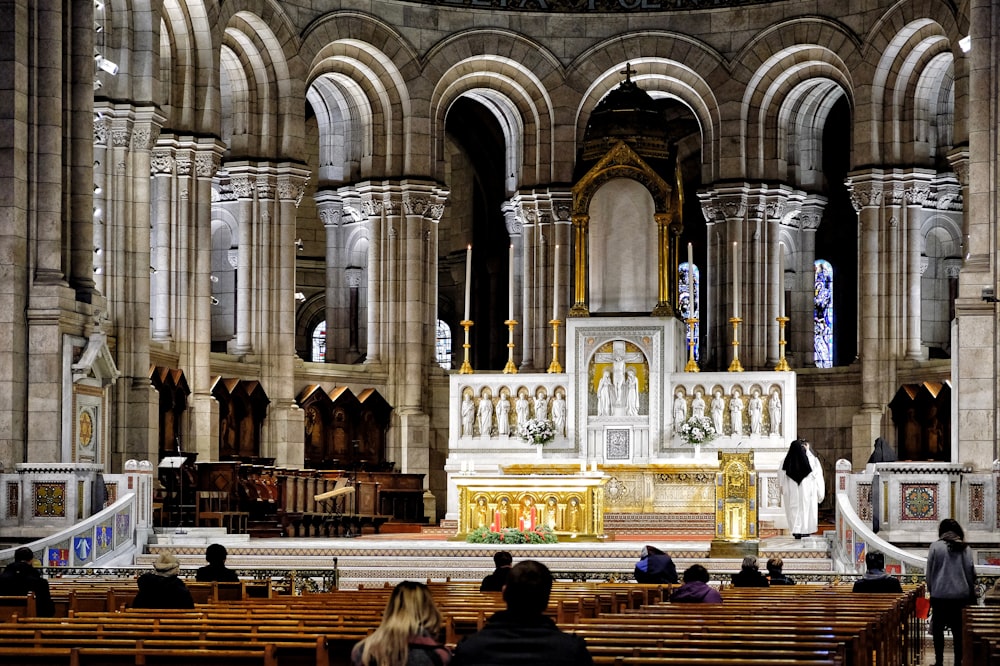 a group of people sitting in a church with pews