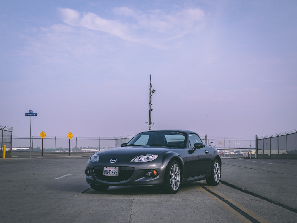 a black sports car parked in a parking lot