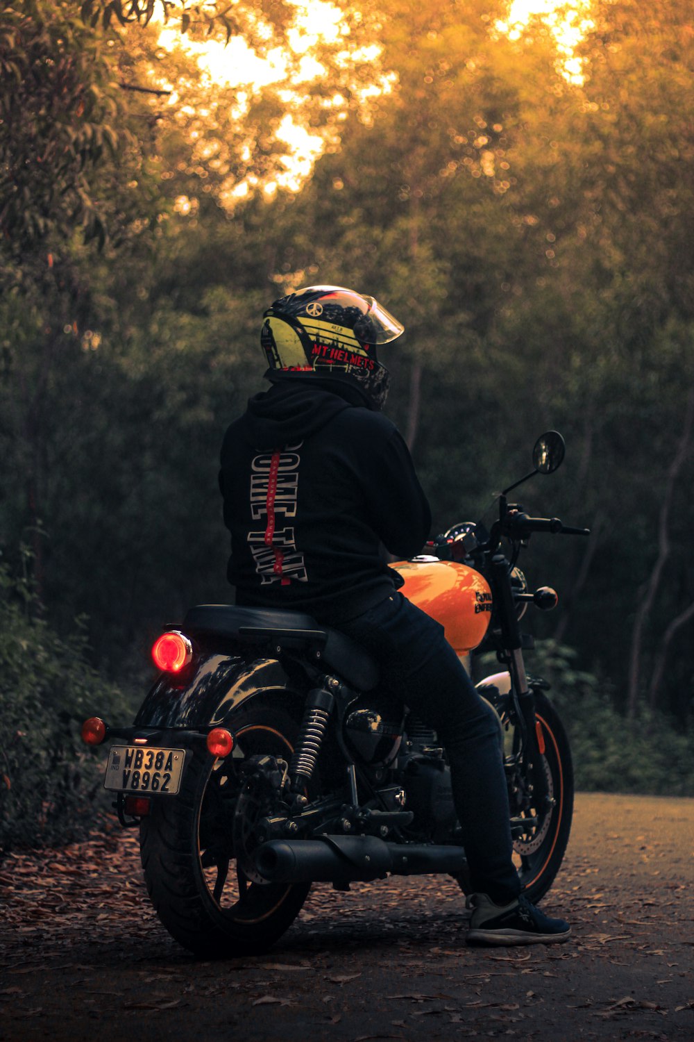 a person sitting on a motorcycle on a road