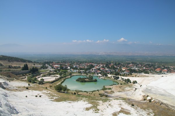 The town and its lake seen from the edge of the travertine slope — Pamukkale, Turkey