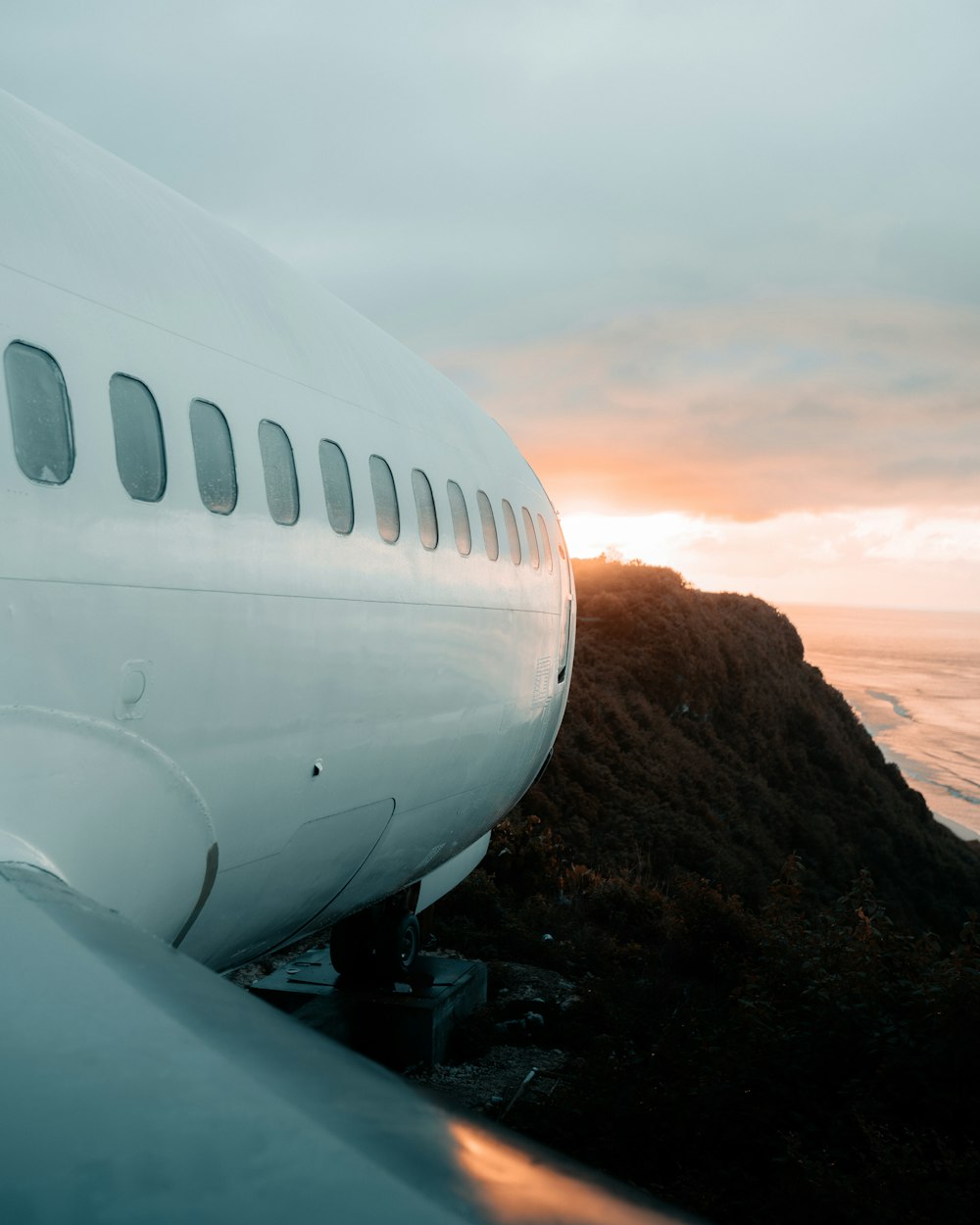 a view of the wing of an airplane as the sun sets