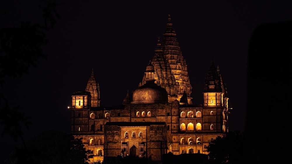 a large building lit up at night in the dark