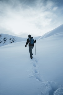 A solo traveler hiking through a scenic mountain trail with a backpack.